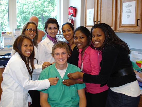 six girls work as a team to check one guys heartbeat