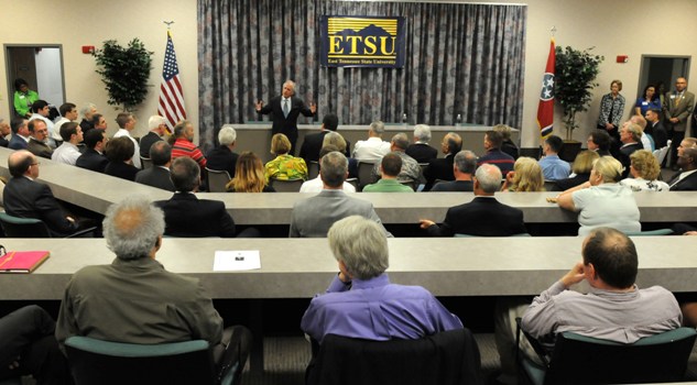 U.S. Senator Bob Corker speaks standing in front of full room with lecture attendees