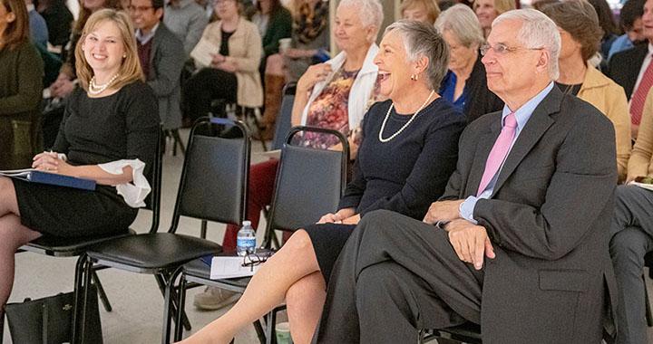 crowd at event laughs and smiles