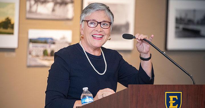 woman speaks at podium