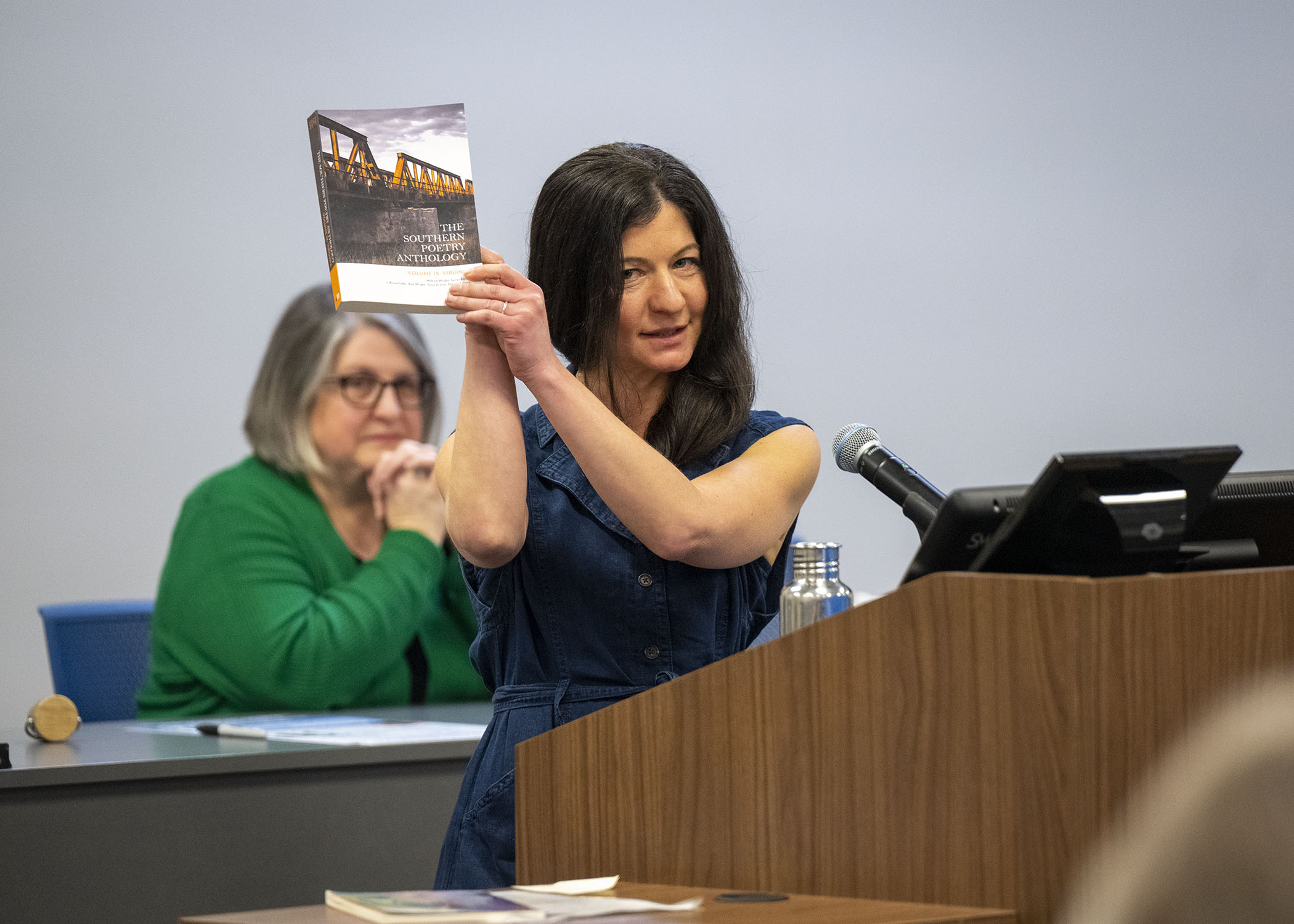 Leah Naomi Green holds up The Southern Poetry Anthology, Volume IX: Virginia​ during her reading. All three of the 3 Emerging Writers appear in this collection edited by Dr. Graves and Dr. Amy Wright, the former ETSU Basler Chair. 