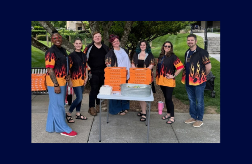 A group of Counseling Center staff dressed in matching shirts celebrate Fairies with Fieries, this time with pizza!