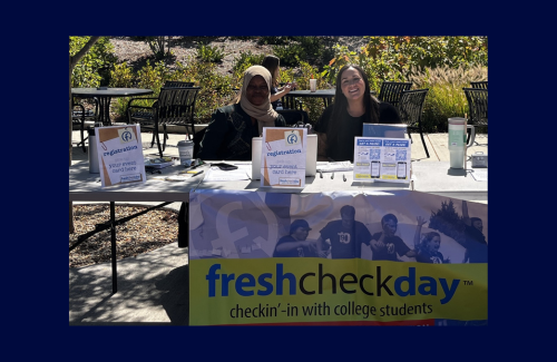 Two Counseling Center staff members welcome students to Fresh Check Day, 2024.