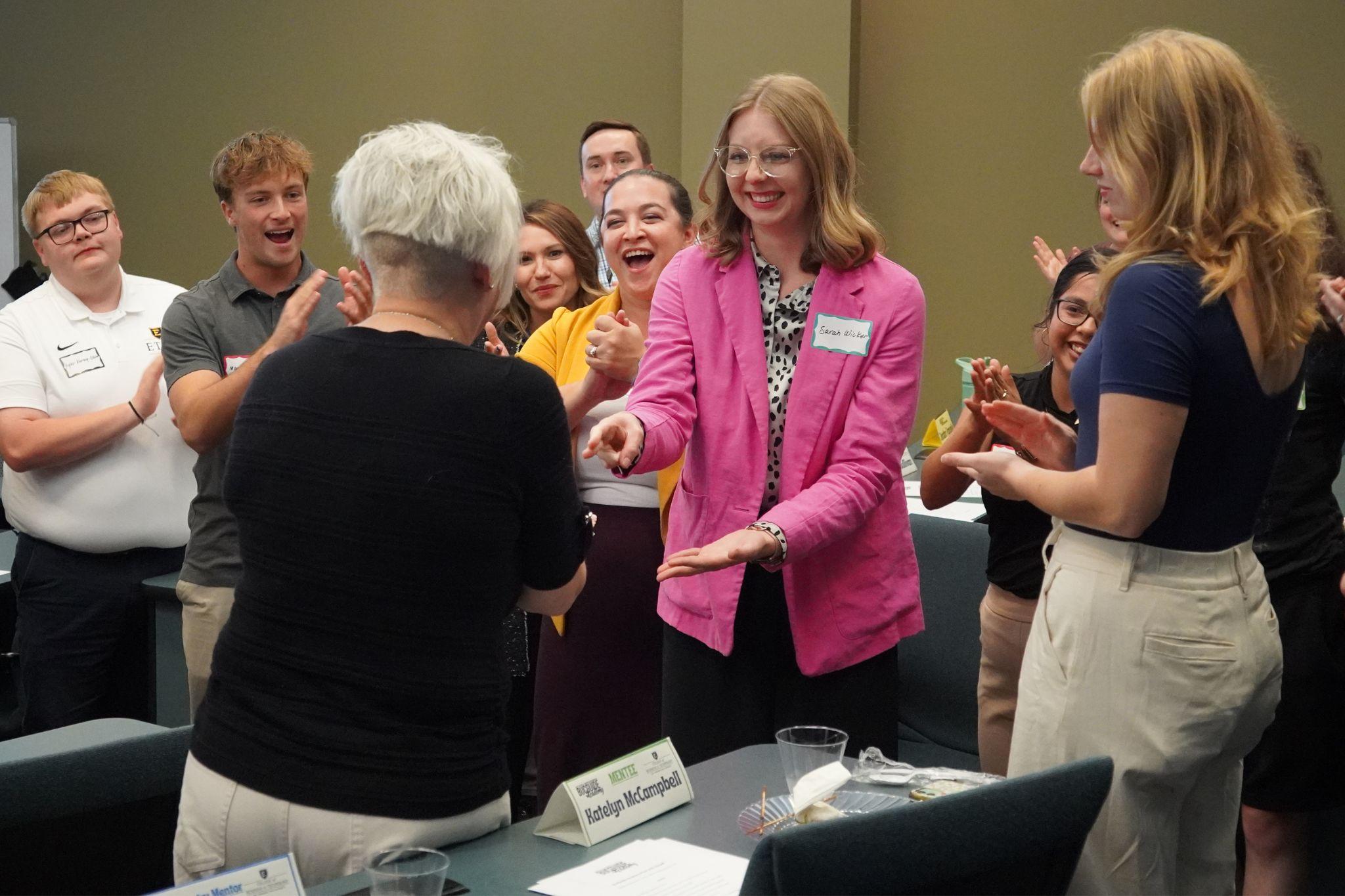 East Tennessee State University faculty, staff, students, and industry partners play rock paper scissors.