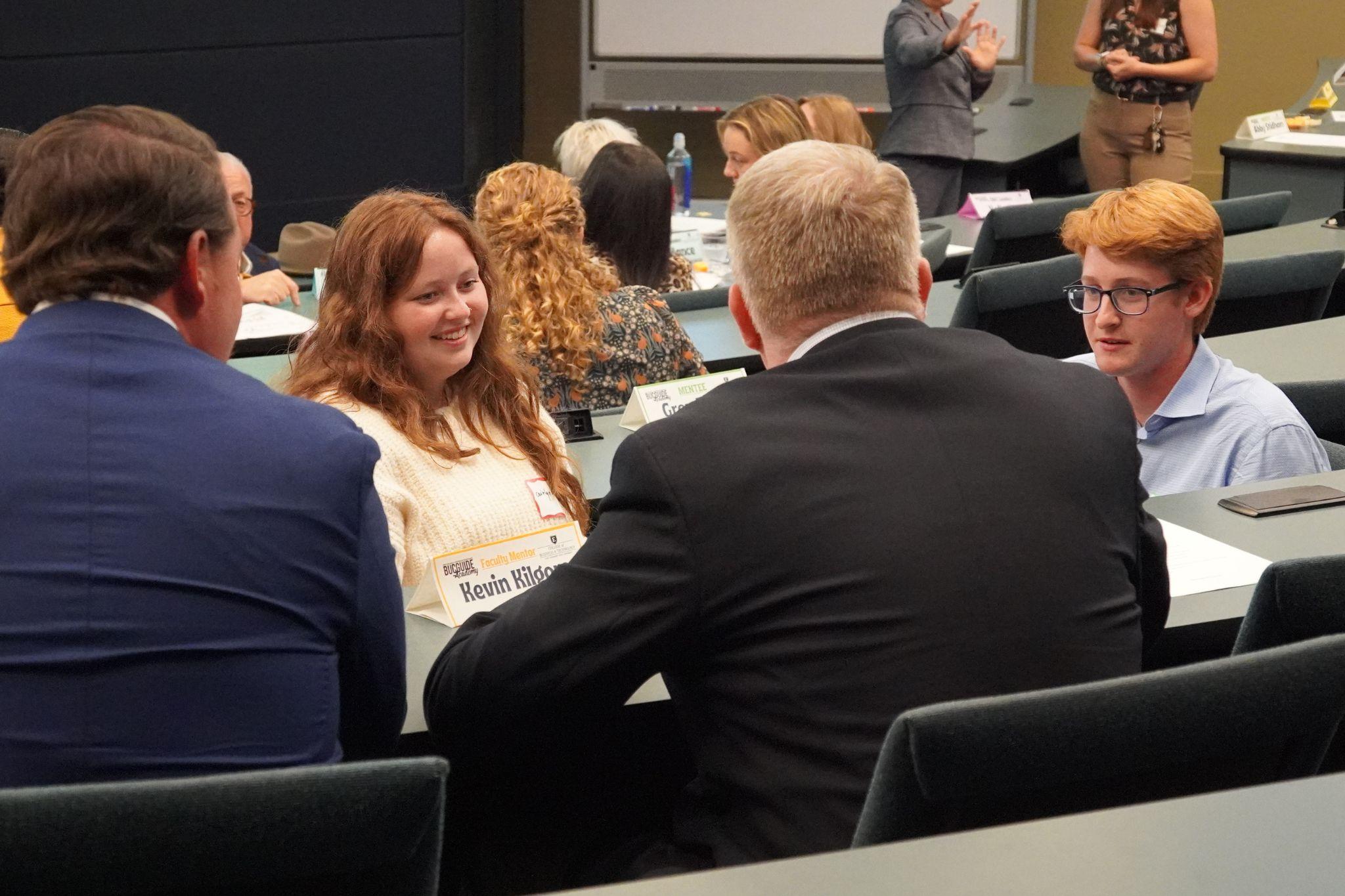 Four East Tennessee State University faculty, staff, students, and industry partners talk to each other during a BucGuide Academy (BGA) meeting.