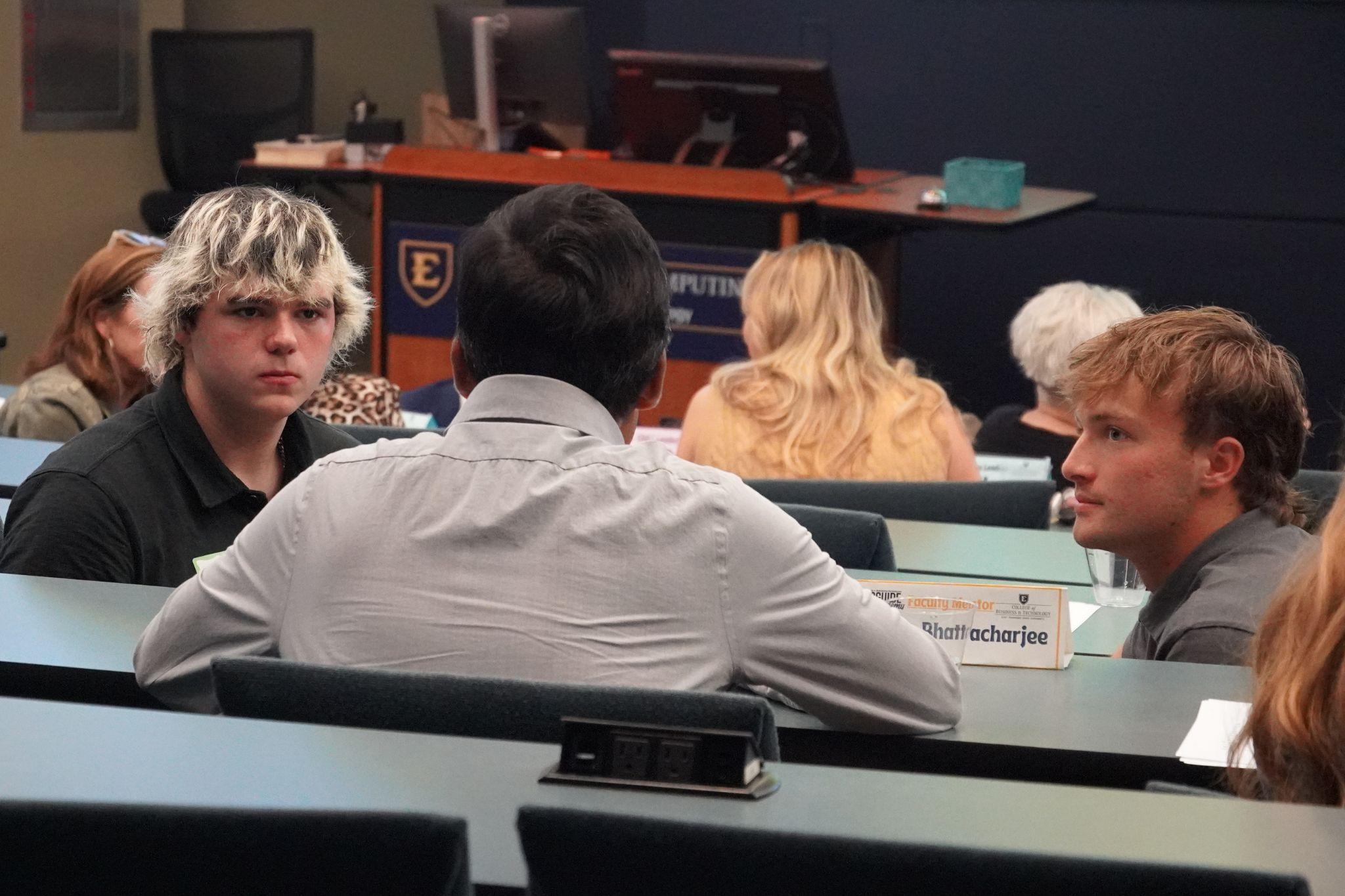 ETSU faculty, staff, students, and industry partners discuss with each other during a BucGuide Academy (BGA) meeting.