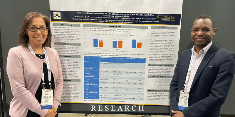 Dr. Khoury and a doctoral student in front of a research poster