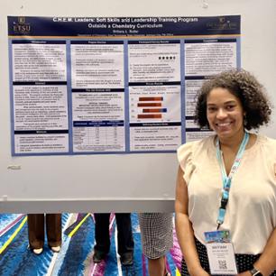 Brittany Butler standing before a board at sermacs