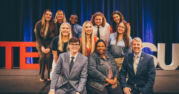 Group photo in front of TED X ETSU logo