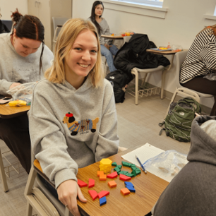 Students working with pattern blocks in primary education class.
