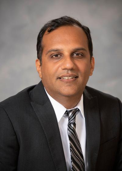 Photo of Dr. Manik Ahuja 
Associate Director
