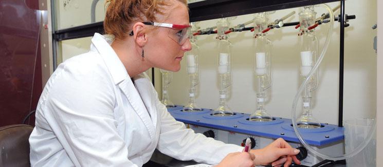 student measuring liquids in the lab
