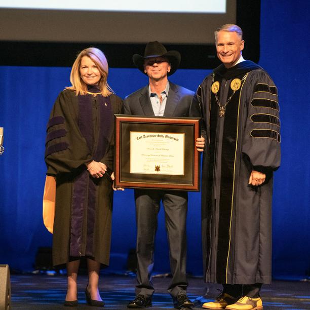 ETSU Provost Dr. Kimberly D. McCorkle and President Dr. Brian Noland are pictured with ETSU alumnus and honorary doctorate recipient Kenny Chesney