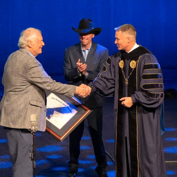 Kenny Chesney applauds Jack Tottle, who is being honored by ETSU President Dr. Brian Noland
