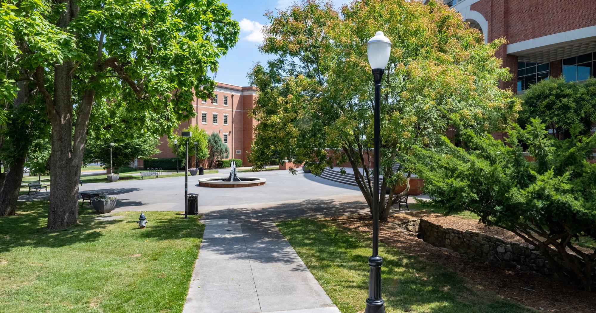 A photo that captures a campus scene with the Sherrod Library in the background.