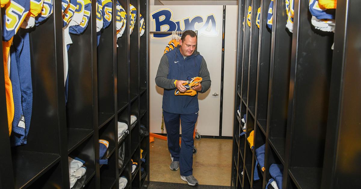 Roger Hammons places freshly laundered uniforms in one of the industrial-sized dryers in ETSU’s athletics equipment management facilities