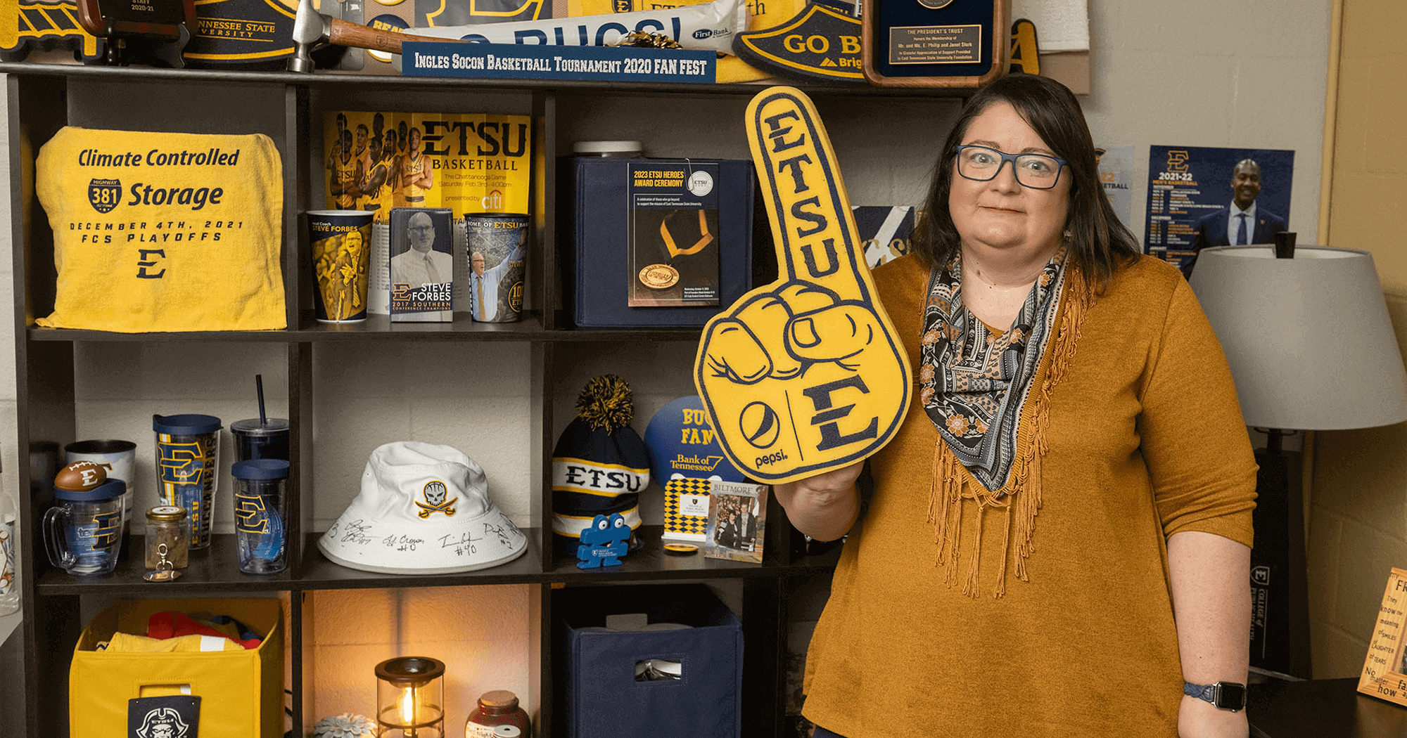 Janet Stork shares some of the Buccaneer gear and memorabilia she proudly displays in her office in the College of Public Health Dean’s Office.