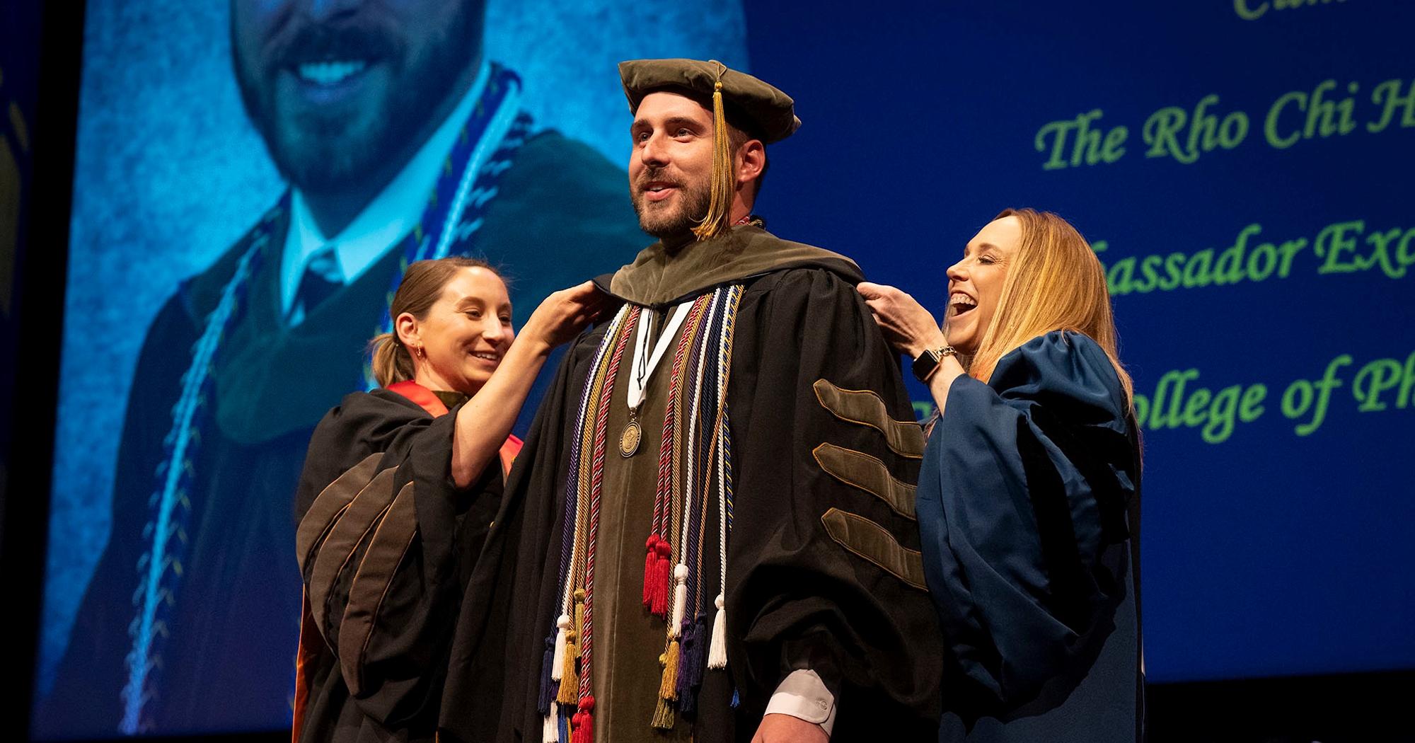 Bill Gatton College of Pharmacy student recieves his doctoral hood at commencement.
