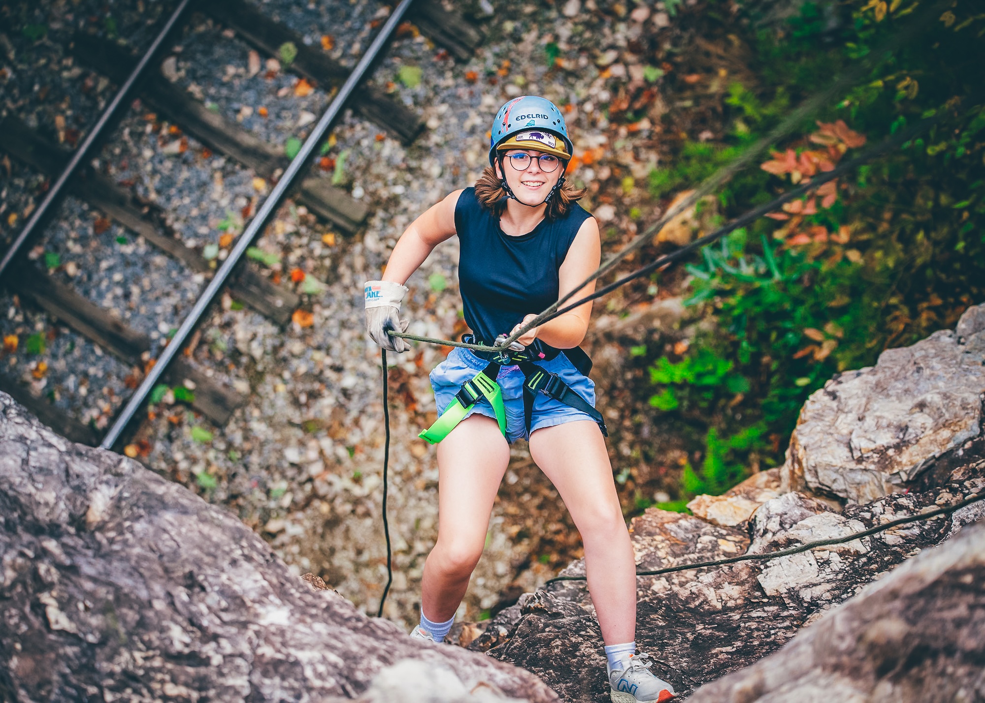 A Roan Scholar rappels down a cliff.