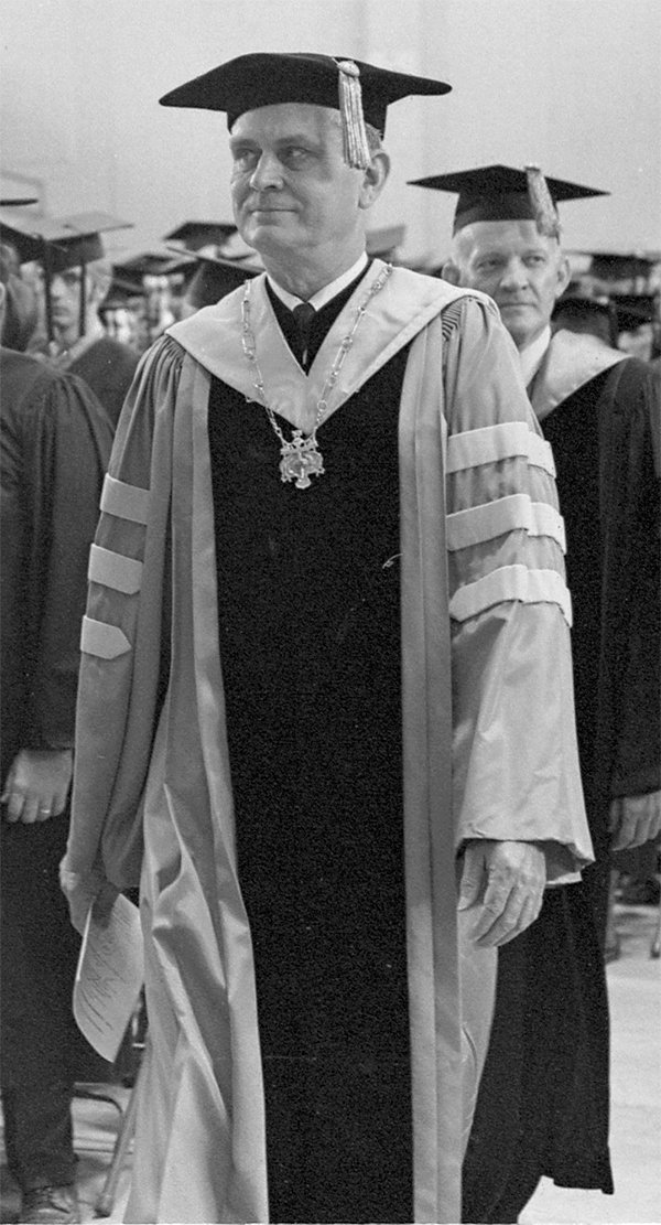 Three male ETSU students relax outside of a residence hall.