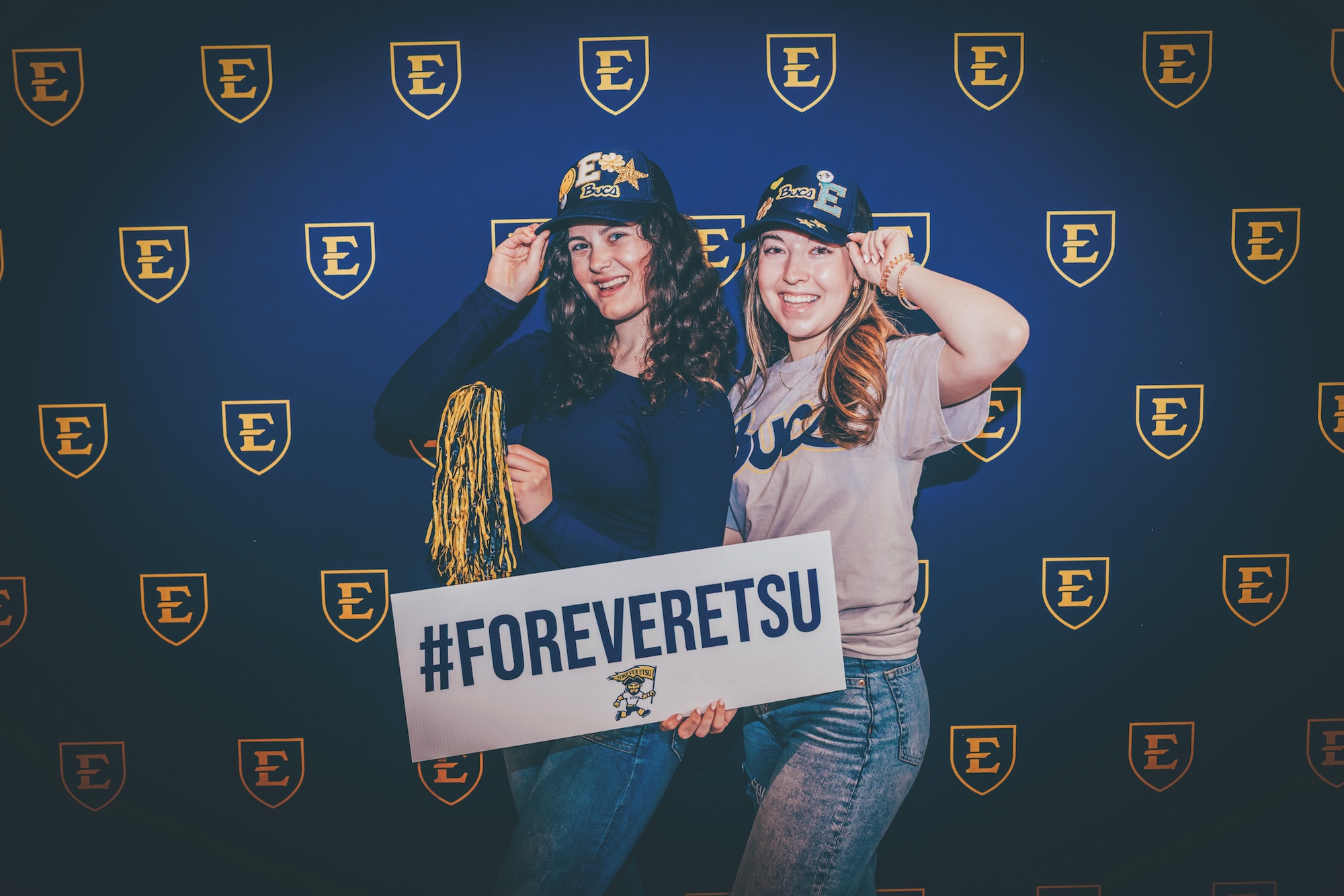 Two ETSU students wearing ETSU swag hold a sign that says “#ForeverETSU.”