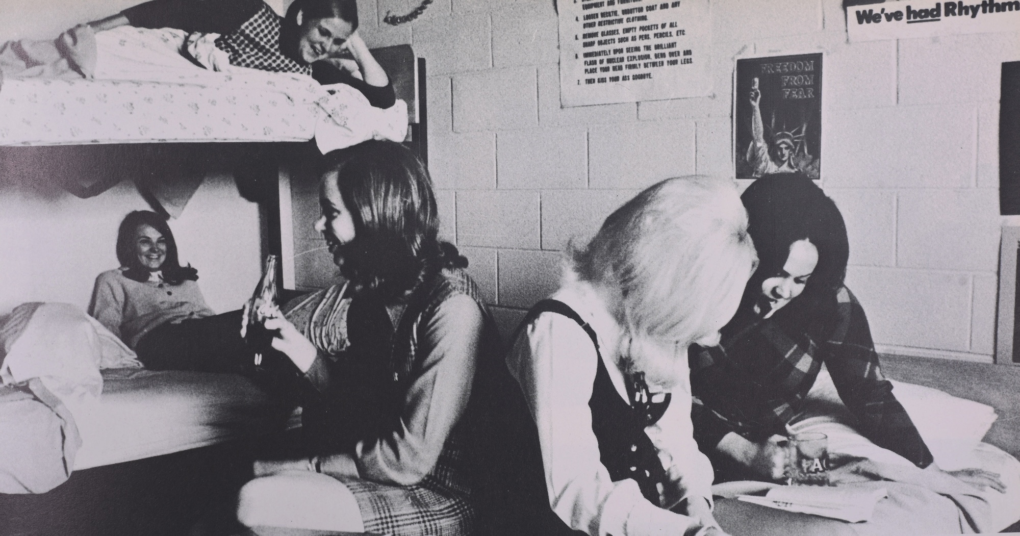 Students hang out on bunk beds in a residence hall.