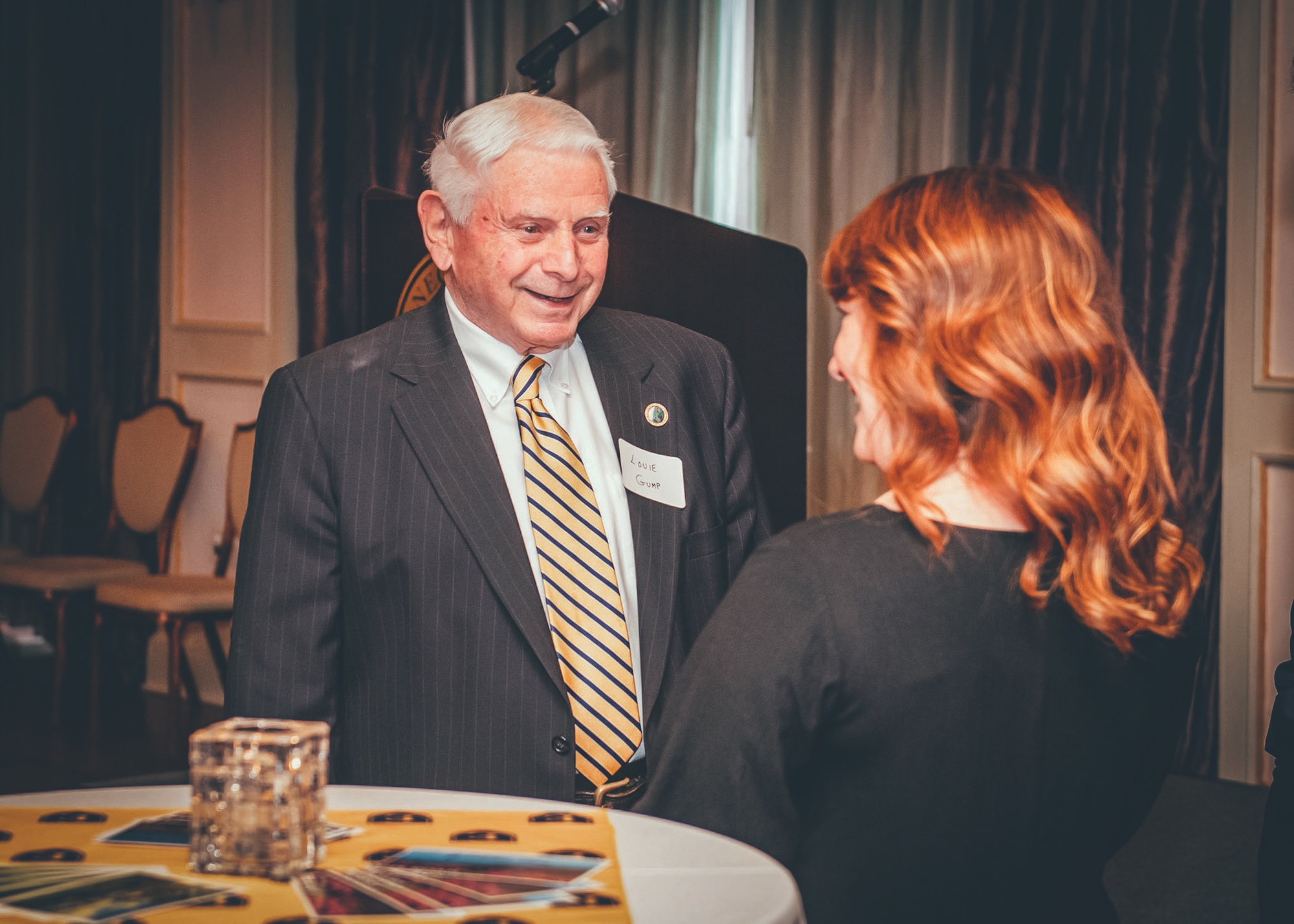 Louie H. Gump, wearing a suit and nametag