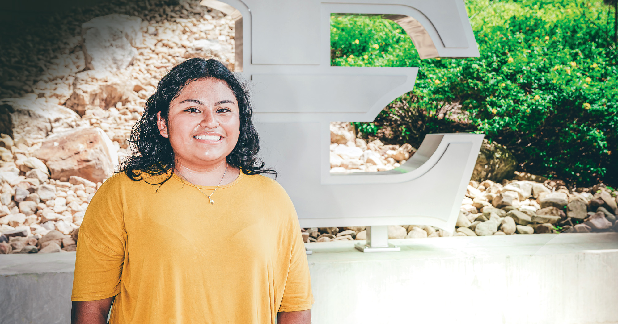 Xochil Munoz stands in front of the large E display outside ETSU’s D.P. Culp Student Center.