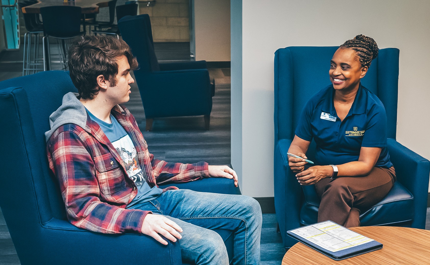 An ETSU staff member speaks with a student