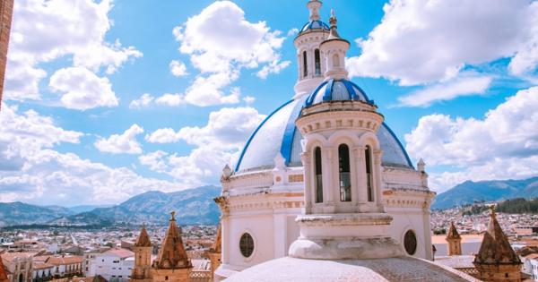 White and blue dome with city and mountains on a sunny day in Cuenca Ecuador