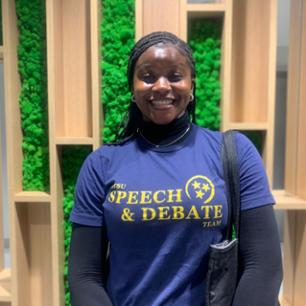 Ijeoma wearing a Speech and Debate Tesm T-shirt