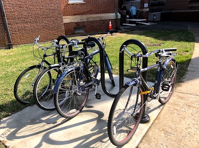 four Buc Bikes bicycles in the bicycle rack outside the Medical Library