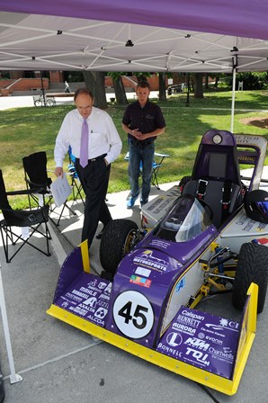 Congressman Phil Roe standing beside NASA car