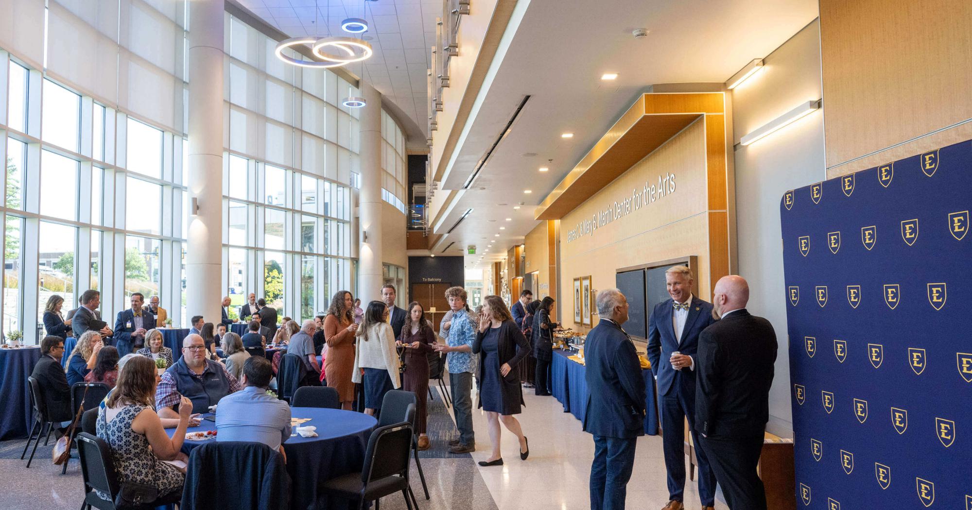 A crowd of ETSU faculty, staff and friends celebrating in the Martin Center Lobby