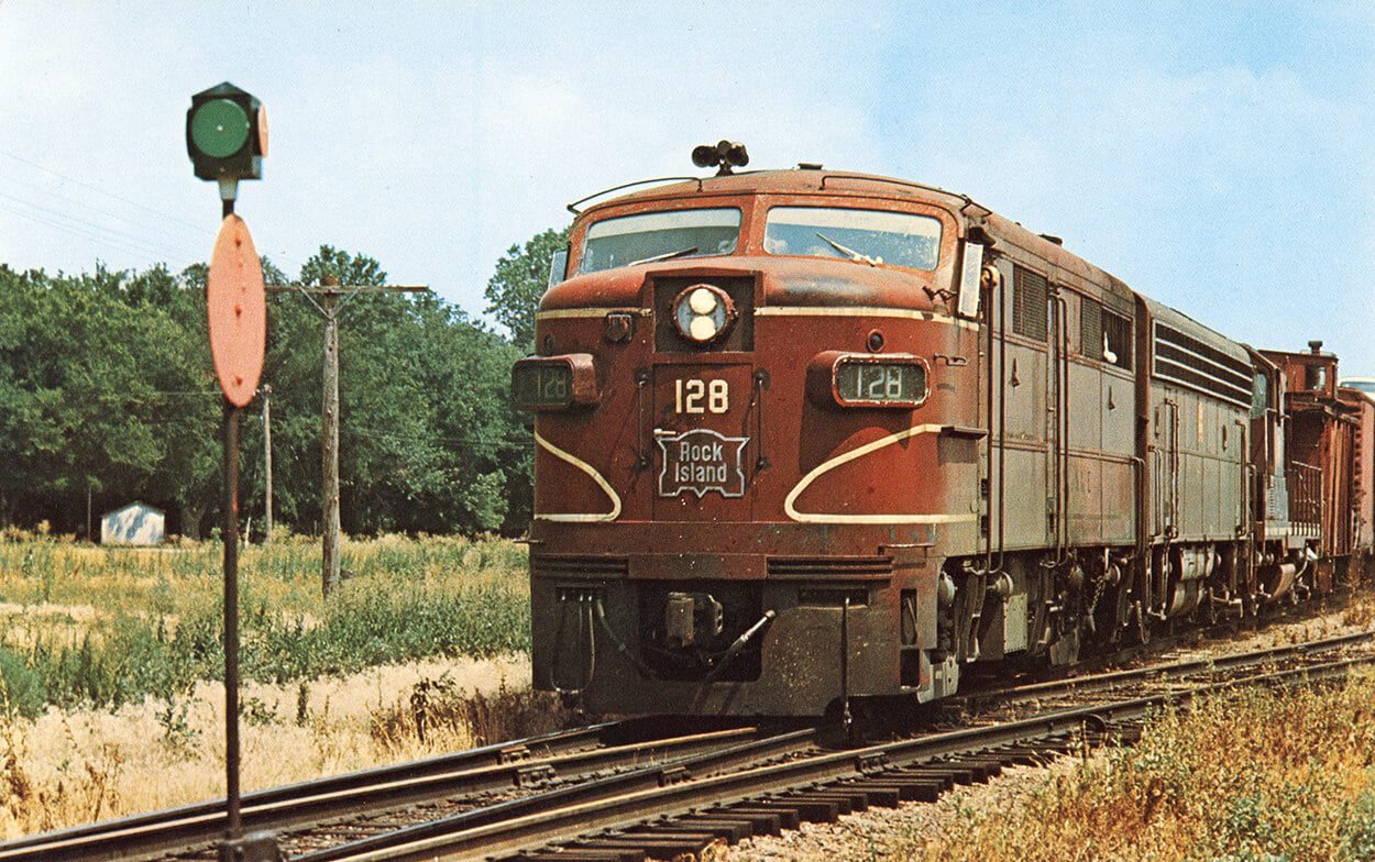 Picture of a Rock Island Railroad diesel locomotive pulling a long freight train.