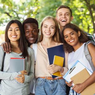 A group of happy students squeeze together for the photo.