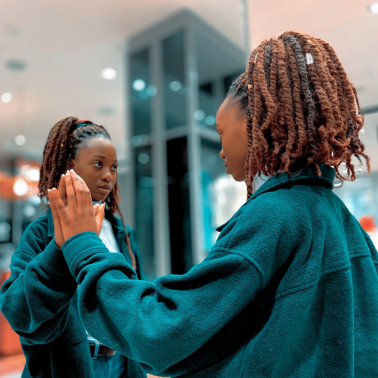 person of color looking in mirror