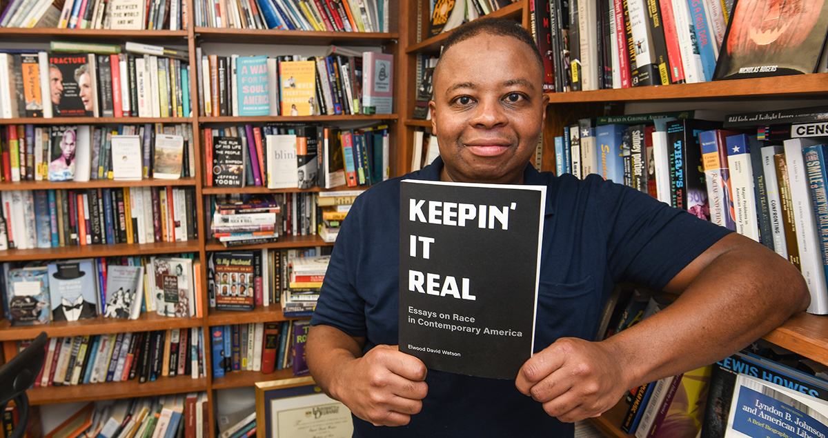 Dr. Elwood Watson, pictured in his office with a copy of "Keepin' It Real" 